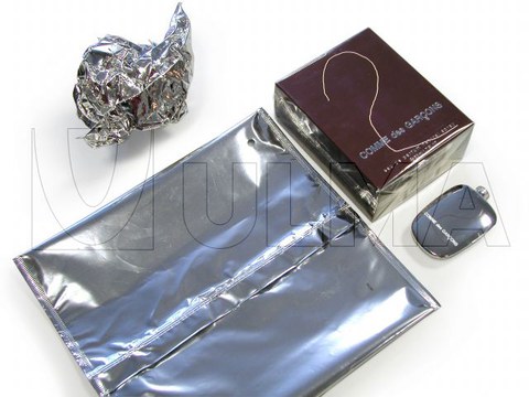 Bottle of perfume packaging in flow pack wrapper (HFFS)